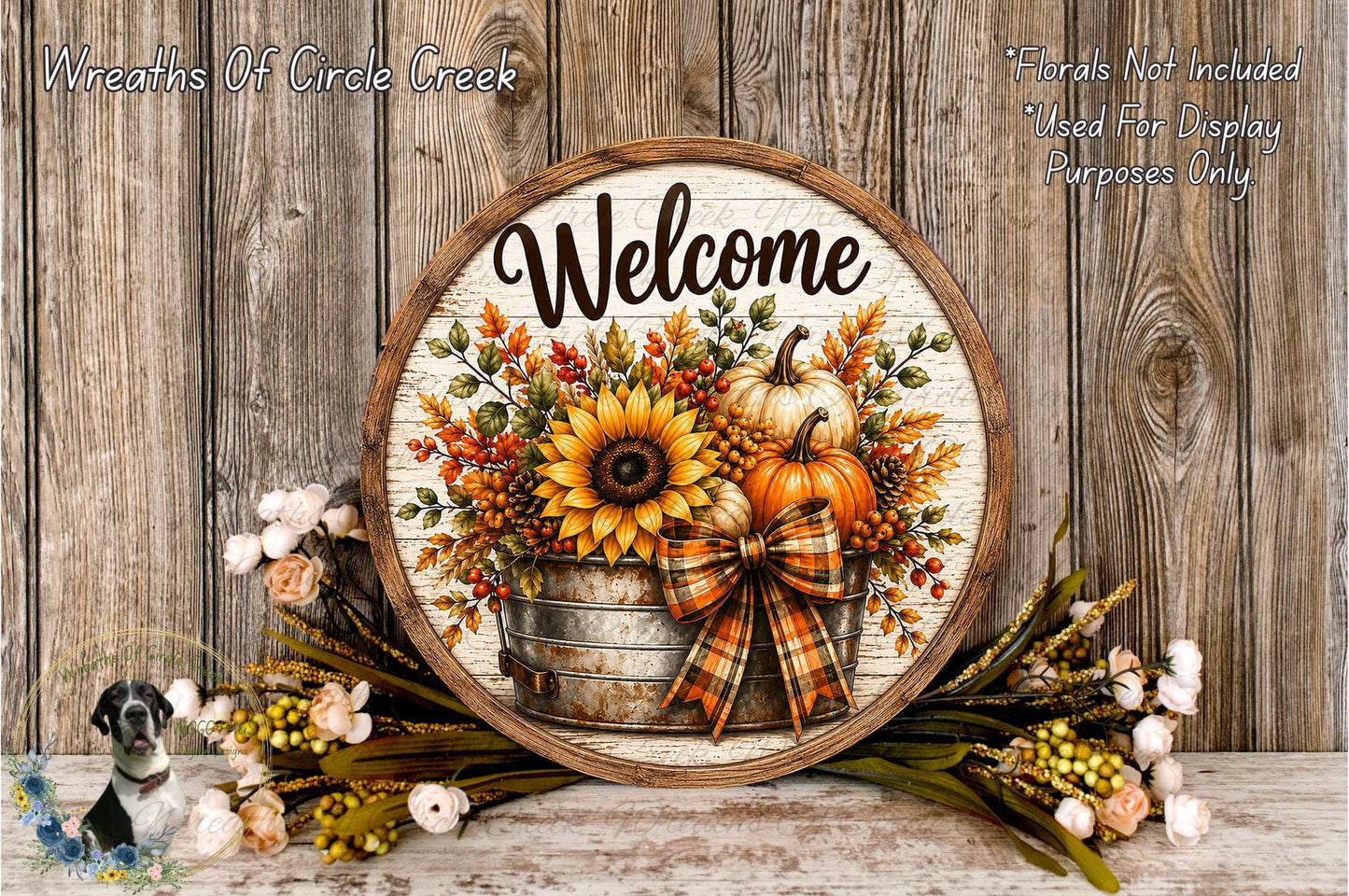a round wooden sign with a welcoming message, surrounded by autumn-themed decorations such as sunflowers, pumpkins, and a bow.