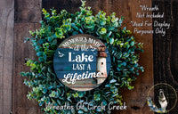 a wreath with a picture of a lighthouse on it