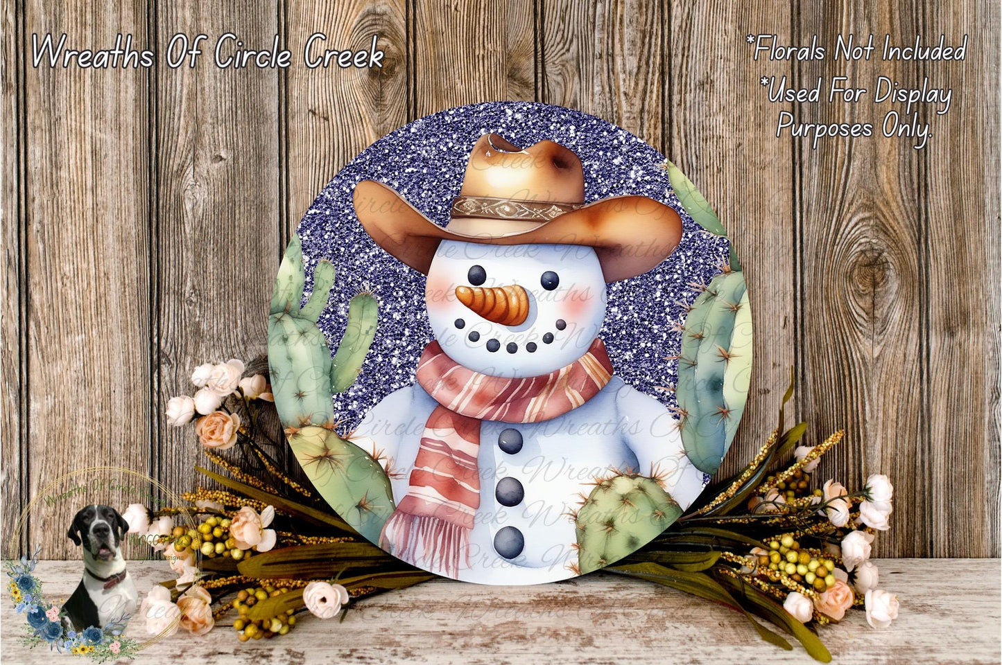 A snowman wearing a cowboy hat and scarf, surrounded by cacti and flowers, with a wooden background.