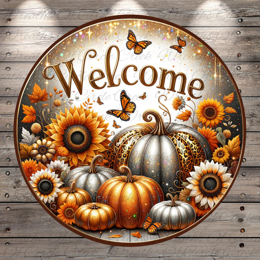 a circular sign with a welcoming message surrounded by autumn-themed elements such as sunflowers, pumpkins, and butterflies.