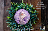 A wreath featuring a purple Santa Claus figure surrounded by green foliage.