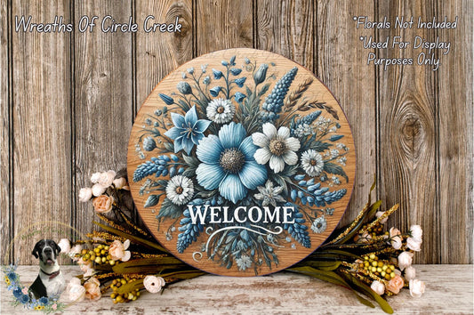 a picture of a welcome sign with flowers on it