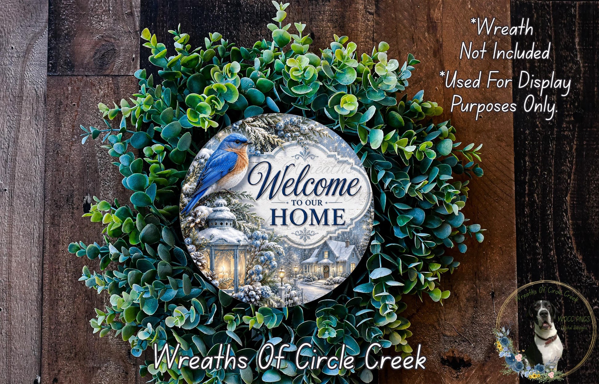 a wreath with a bird and a sign that says "Welcome to our Home". The wreath is made of green leaves and has a wooden background.