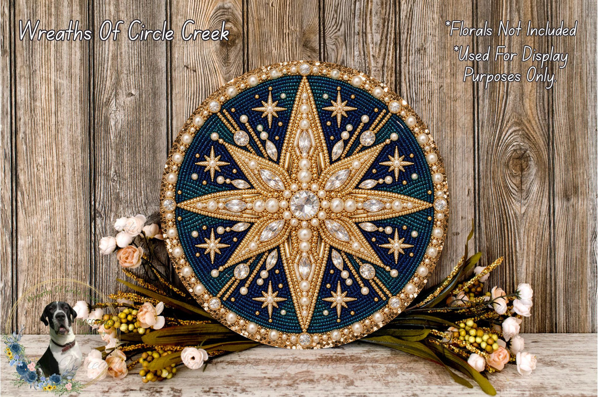 a decorative round wreath with a star design, placed on a wooden surface. The wreath is adorned with gold and blue elements, and it is surrounded by a variety of flowers and greenery.