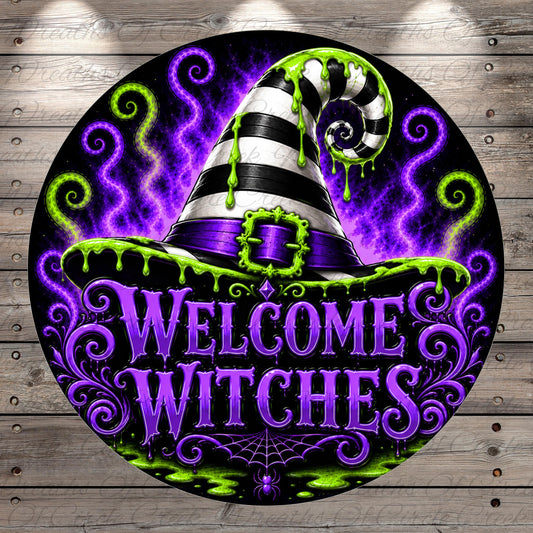 A circular sign with a black and white witch's hat, surrounded by swirling purple and green lights, and the text "Welcome Witches" prominently displayed.