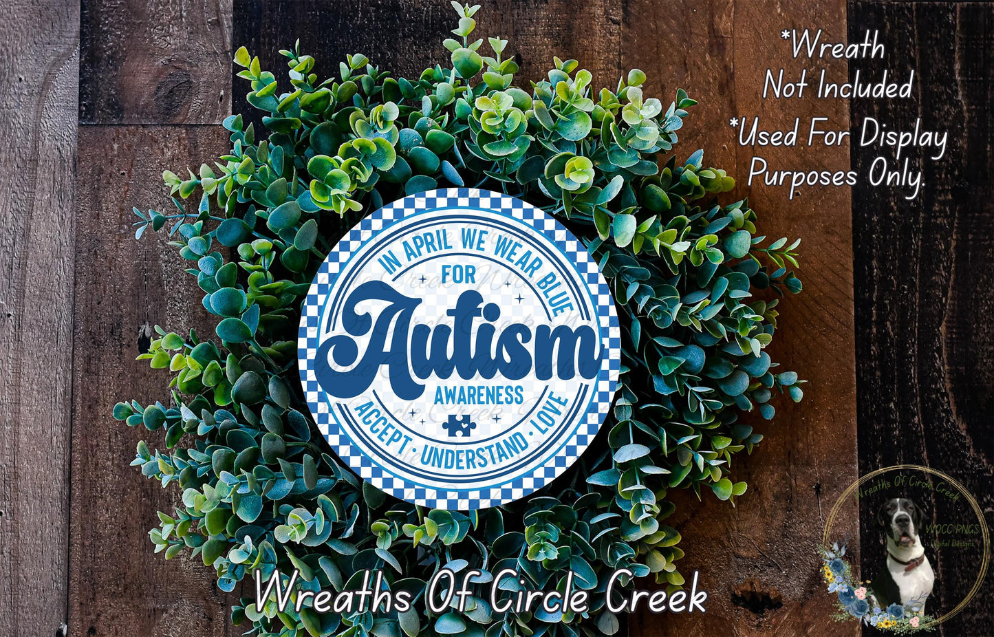 a wreath made of green leaves and a blue and white sign that reads "Autism Awareness Accept, Understand, Love" surrounded by a wooden background.