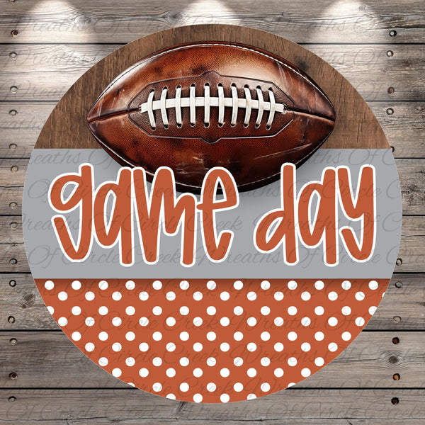 a football and the text "game day" in a circular arrangement on a wooden background.