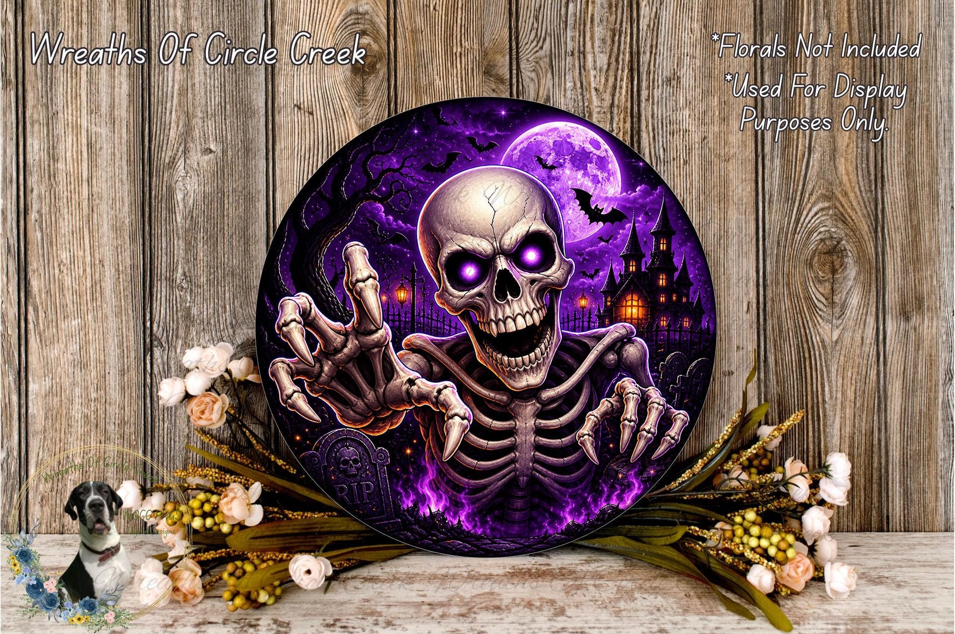 a skull with glowing eyes and a skeletal appearance, surrounded by a spooky purple and black background with a full moon, bats, and a castle. The skull is holding a claw and appears to be in a menacing pose. The image is described as a "Wreaths of Circle Creek" and a "Wreath of Halloween", suggesting it is a Halloween-themed decoration.