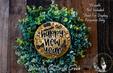 A wreath made of green leaves and a golden circular sign that says "Happy New Year".