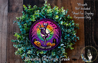 a wreath with a skeleton and pumpkins on it