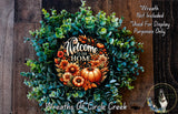 a wreath made of various fall-themed elements, including greenery, pumpkins, and flowers, with a welcoming message that reads "Welcome to our Home".