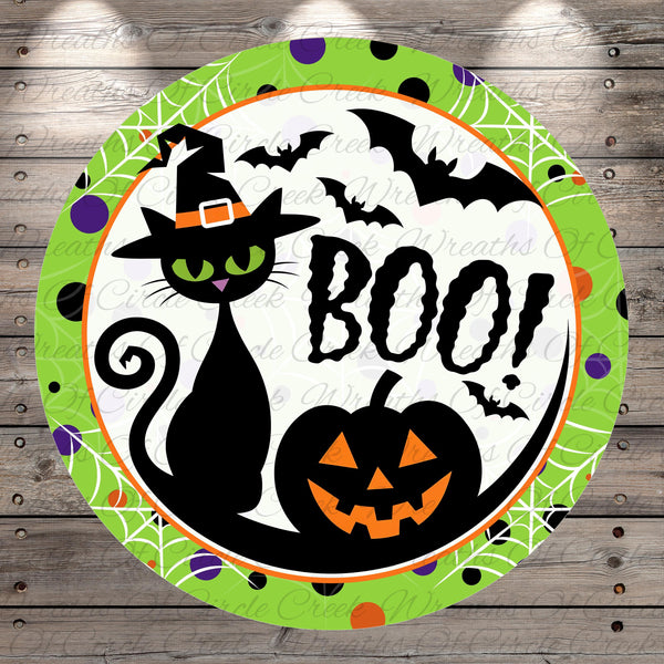A black cat wearing a witch's hat and surrounded by Halloween-themed elements, including bats, a pumpkin, and the word "BOO!"