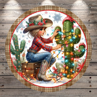 A woman in a cowboy hat sits on a suitcase, surrounded by a festive Christmas scene with a cactus and colorful lights.