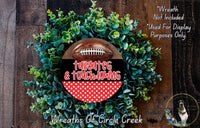 a wreath made of green foliage and a football, with the text "Tailgates & Touchdowns" displayed on it.