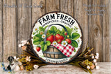 a rustic wooden wall with a round metal sign that reads "Farm Fresh Handpicked Organic Strawberries". The sign is surrounded by a basket of fresh strawberries and a wreath of flowers, creating a charming and inviting display.