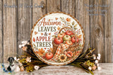a round wooden sign with a decorative design, surrounded by autumn-themed decorations such as flowers and leaves, and a basket of apples.
