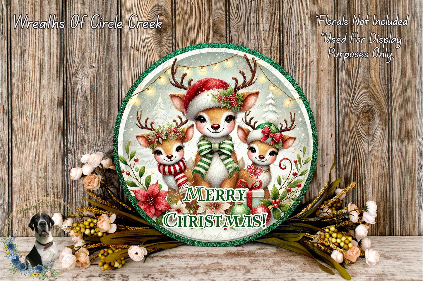A festive Christmas wreath with three deer wearing Santa hats and scarves, surrounded by flowers and greenery, with the text "Merry Christmas!" displayed on the wreath.