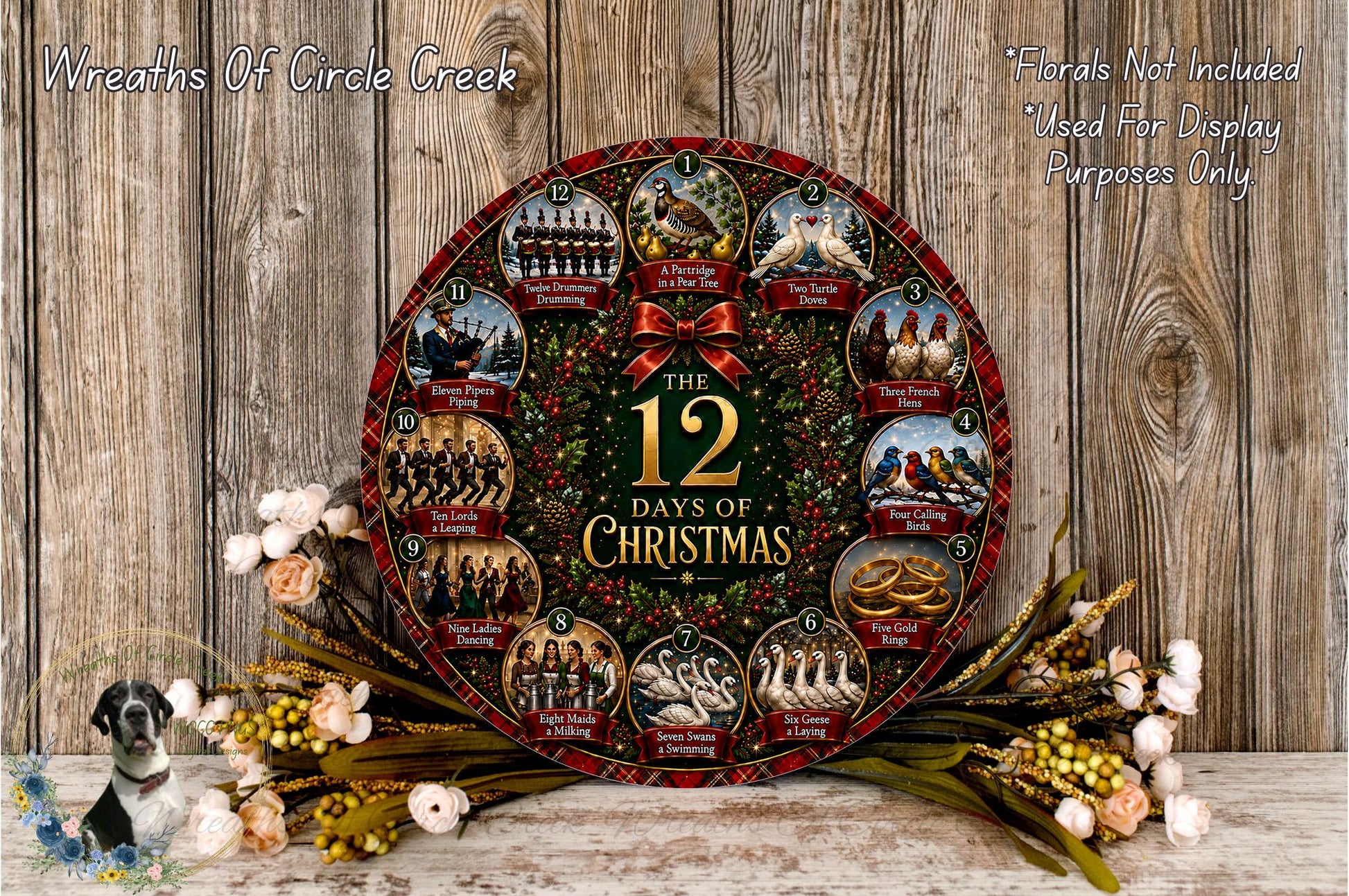 A decorative Christmas wreath with the text "The 12 Days of Christmas" displayed prominently. The wreath is surrounded by flowers and placed on a wooden surface.