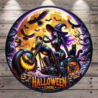 The image is a Halloween-themed illustration featuring a woman dressed as a witch riding a motorcycle, surrounded by jack-o-lanterns, bats, and a full moon.