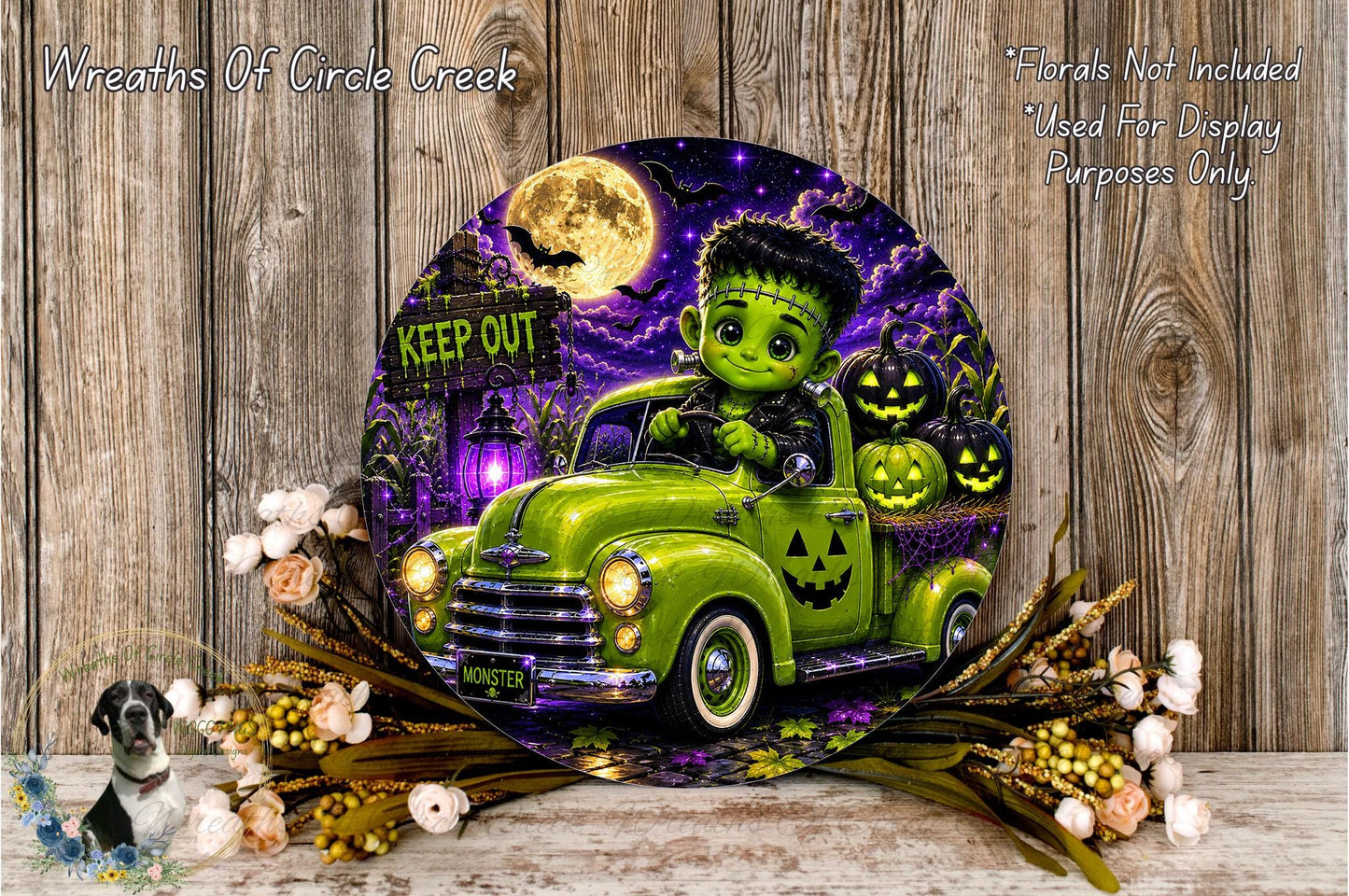 A Halloween-themed wall decoration featuring a green truck with a creepy-looking character on the front, surrounded by pumpkins and flowers.