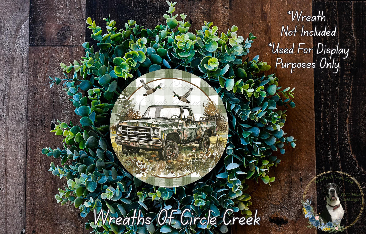 A wreath made of green foliage and a circular plate featuring a truck and birds in a wooded setting.