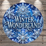 A circular sign with a winter wonderland theme, featuring snowflakes, trees, and sparkling lights against a dark blue background.