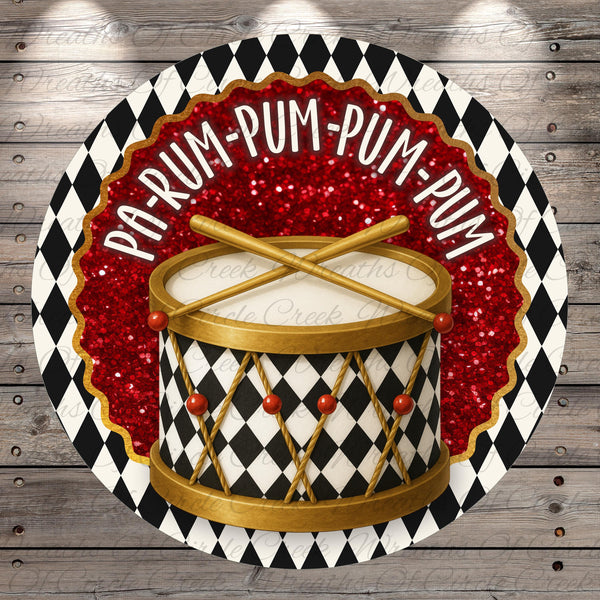a drum with a black and white checkered pattern and red glitter accents, surrounded by a decorative border with the text "PAP-RUM-PUM-PUM" written on it.