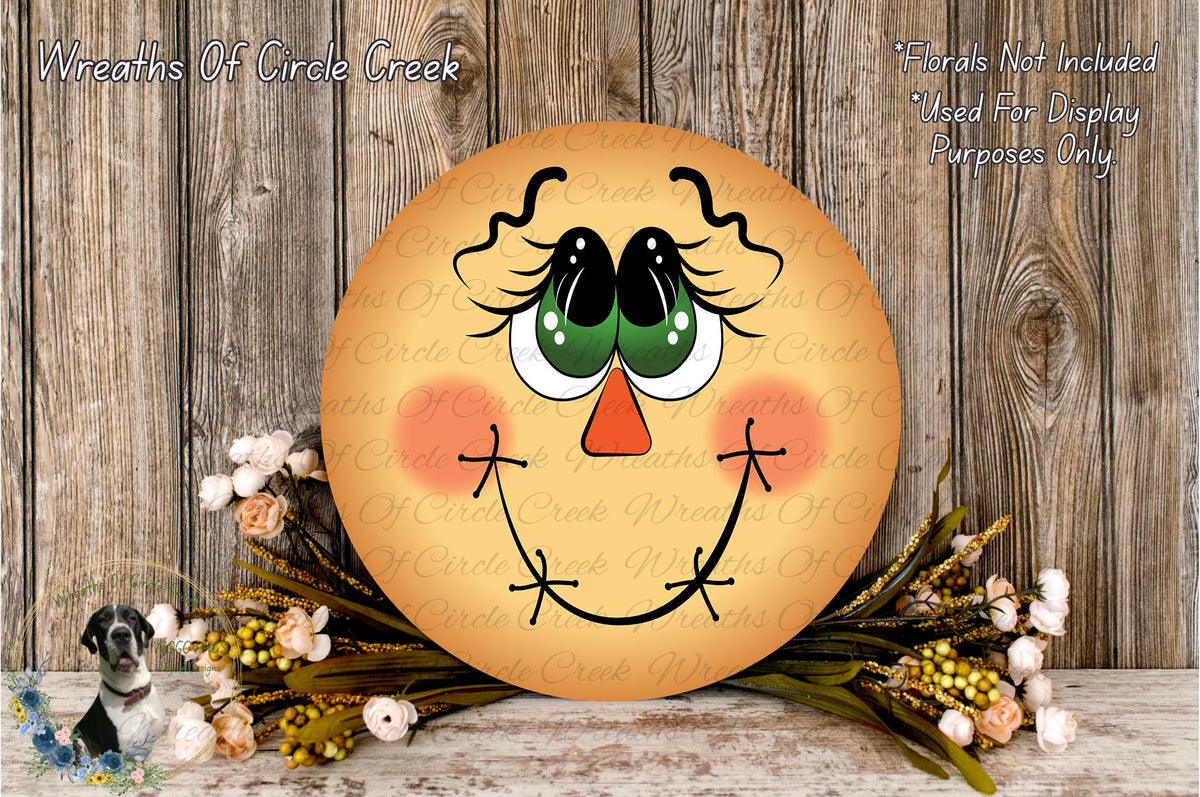 a round wooden sign with a smiling face, surrounded by flowers and placed on a wooden surface.