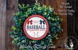 A wreath made of green foliage with a red and white baseball-themed sign in the center, surrounded by text.