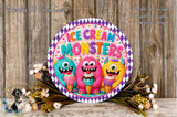 a round sign with the text "ICECREAM MONSTERS" and three cartoon monster characters holding ice cream cones. The sign is surrounded by flowers and placed on a wooden surface.