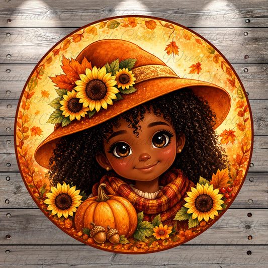 A young girl with curly hair wearing a large orange hat decorated with sunflowers and surrounded by autumn leaves and a pumpkin.