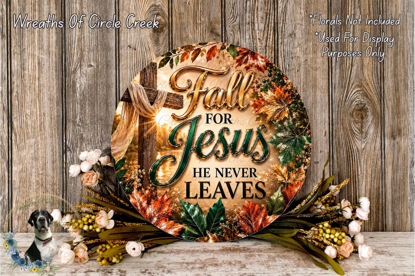 a circular sign with the text "Fall for Jesus he never leaves" surrounded by a wreath of flowers and leaves.
