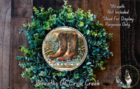 a wreath made of green foliage and brown boots, with the phrase "KICK OFF YOUR BOOSTERS" displayed on the wreath.
