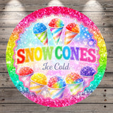 A colorful circular sign with the text "SNOW CONES Ice Cold" surrounded by a glittery border and illustrations of rainbow-colored snow cones.