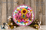A decorative wreath with the word "MOM" prominently displayed in the center, surrounded by a variety of colorful flowers and foliage.