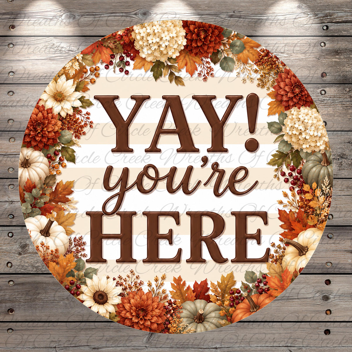 A circular sign with the text "YAY! you're here" surrounded by a wreath of autumn flowers and leaves.