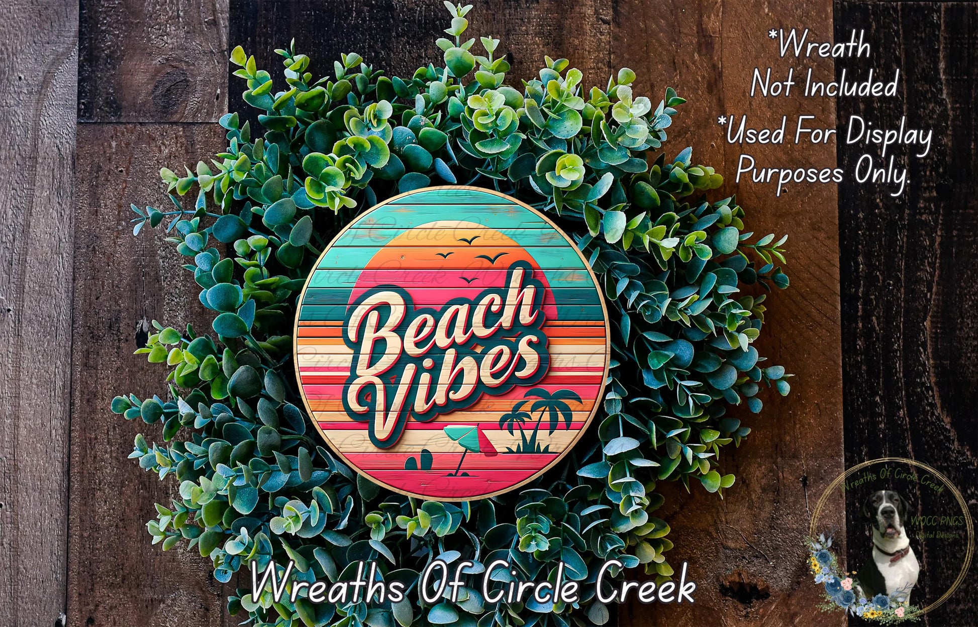 a wreath made of green plants and a circular sign with the text "Beach Vibes" on it, placed on a wooden surface.