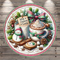 A festive Christmas-themed arrangement featuring a snowman, a mug of hot chocolate, cookies, and other holiday decorations on a wooden background.