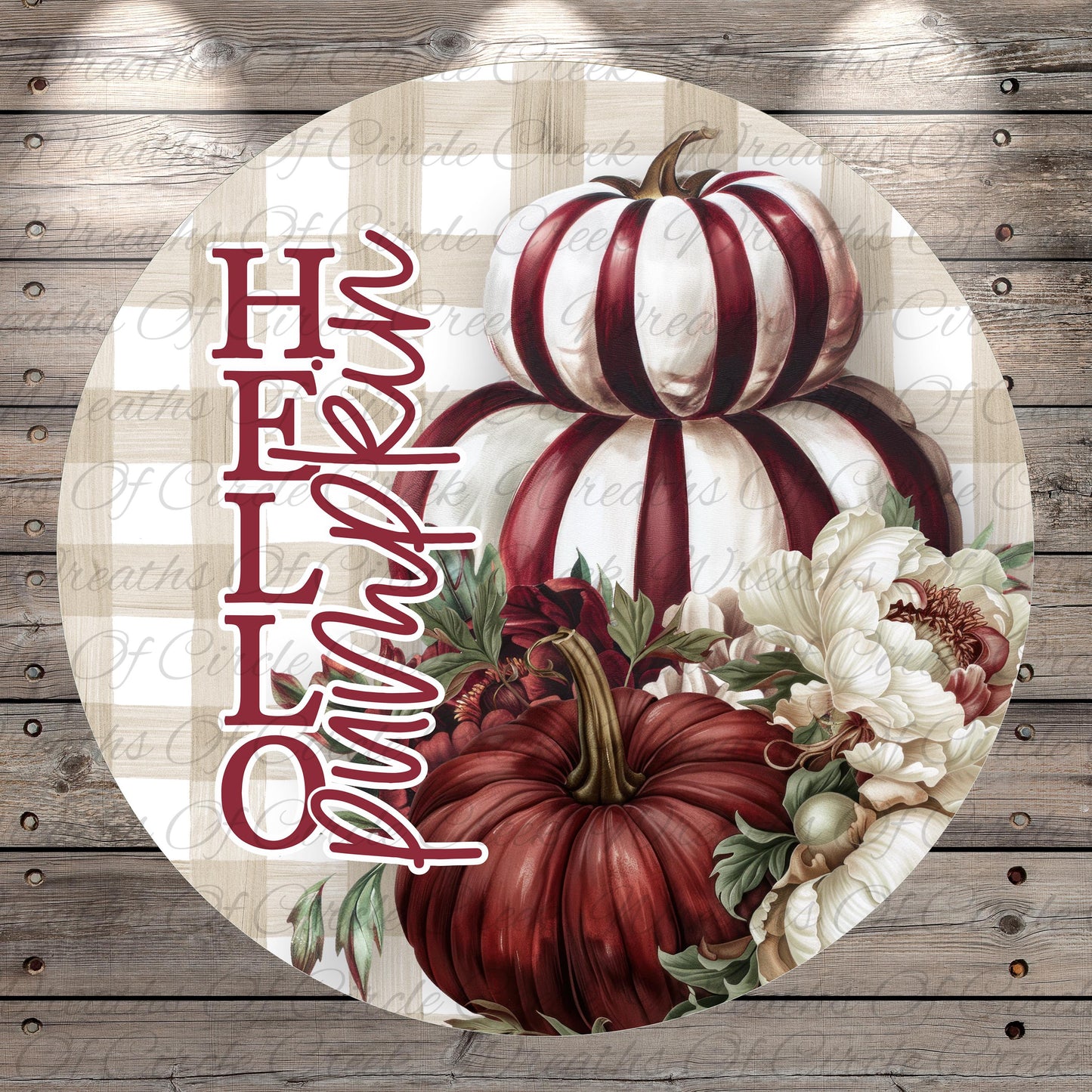 A circular sign with a floral design featuring two large pumpkins and white and red flowers, along with the text "Hello" written in cursive.