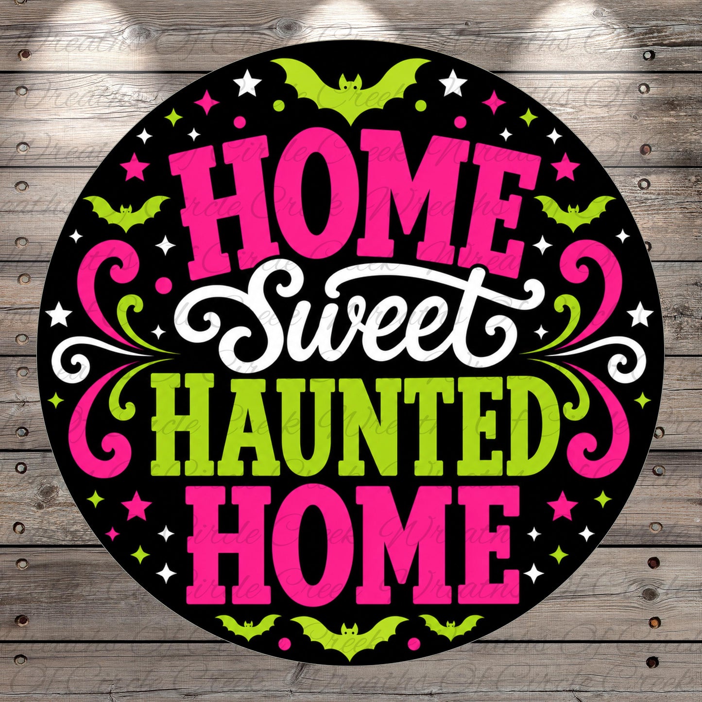 a circular graphic with the text "HOME Sweet Haunted Home" in a stylized font, surrounded by decorative elements such as bats, stars, and swirls in pink, green, and white colors.