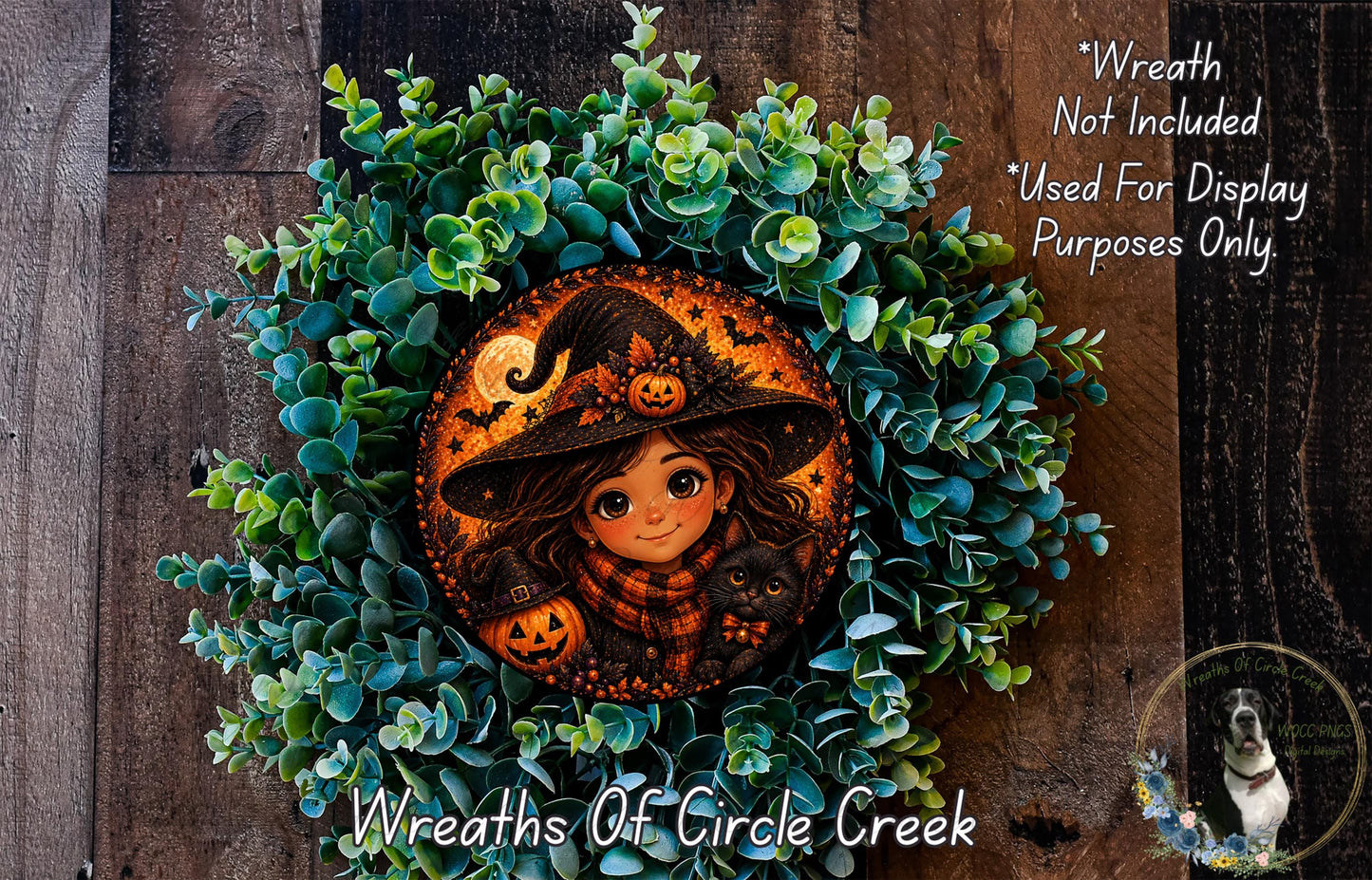 A wreath featuring a cartoon girl wearing a witch's hat and holding a pumpkin, surrounded by green foliage.