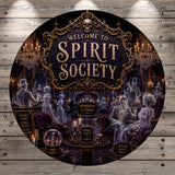 The image is a circular sign with a dark, gothic-inspired theme, featuring a skeleton, chandeliers, and other ghostly figures. The sign prominently displays the text "Welcome to Spirit Society" and includes details about membership, such as "TONIGHT'S SERIE", "ELEGANT", and "KINDLY FADE IN".