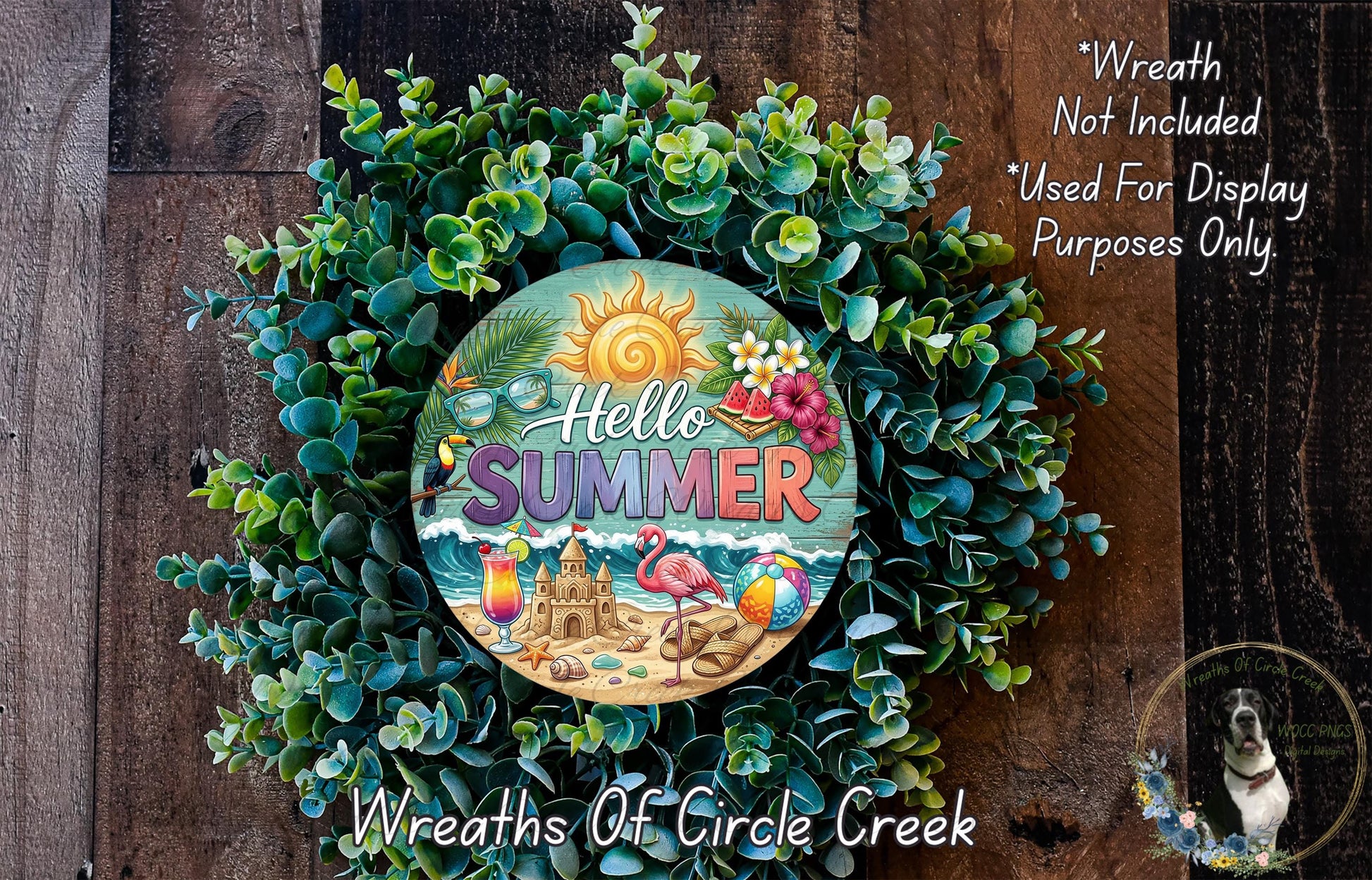 A wreath made of green leaves and flowers, with a circular sign in the center that says "Hello Summer" and features a beach scene with a sandcastle, palm tree, and flamingo.