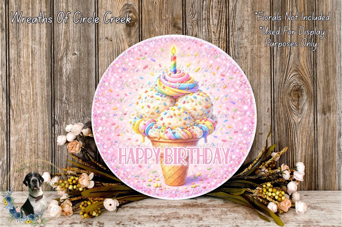A round birthday wreath with a colorful ice cream cone and a candle on top, surrounded by flowers and a wooden background.