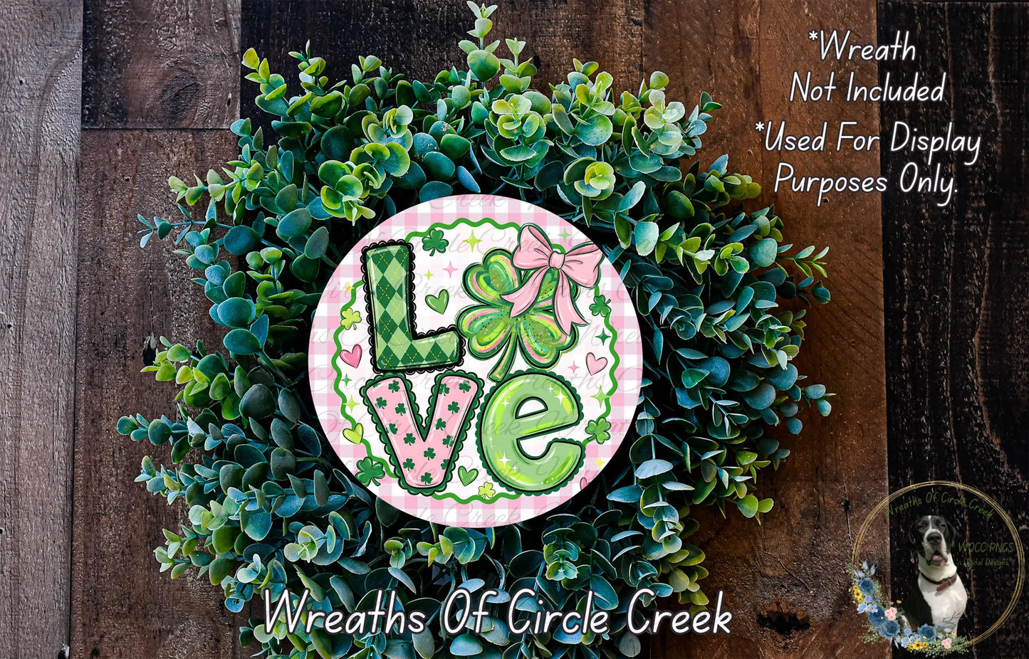 A wreath made of green leaves and flowers, with the word "Love" written on it in a decorative font.