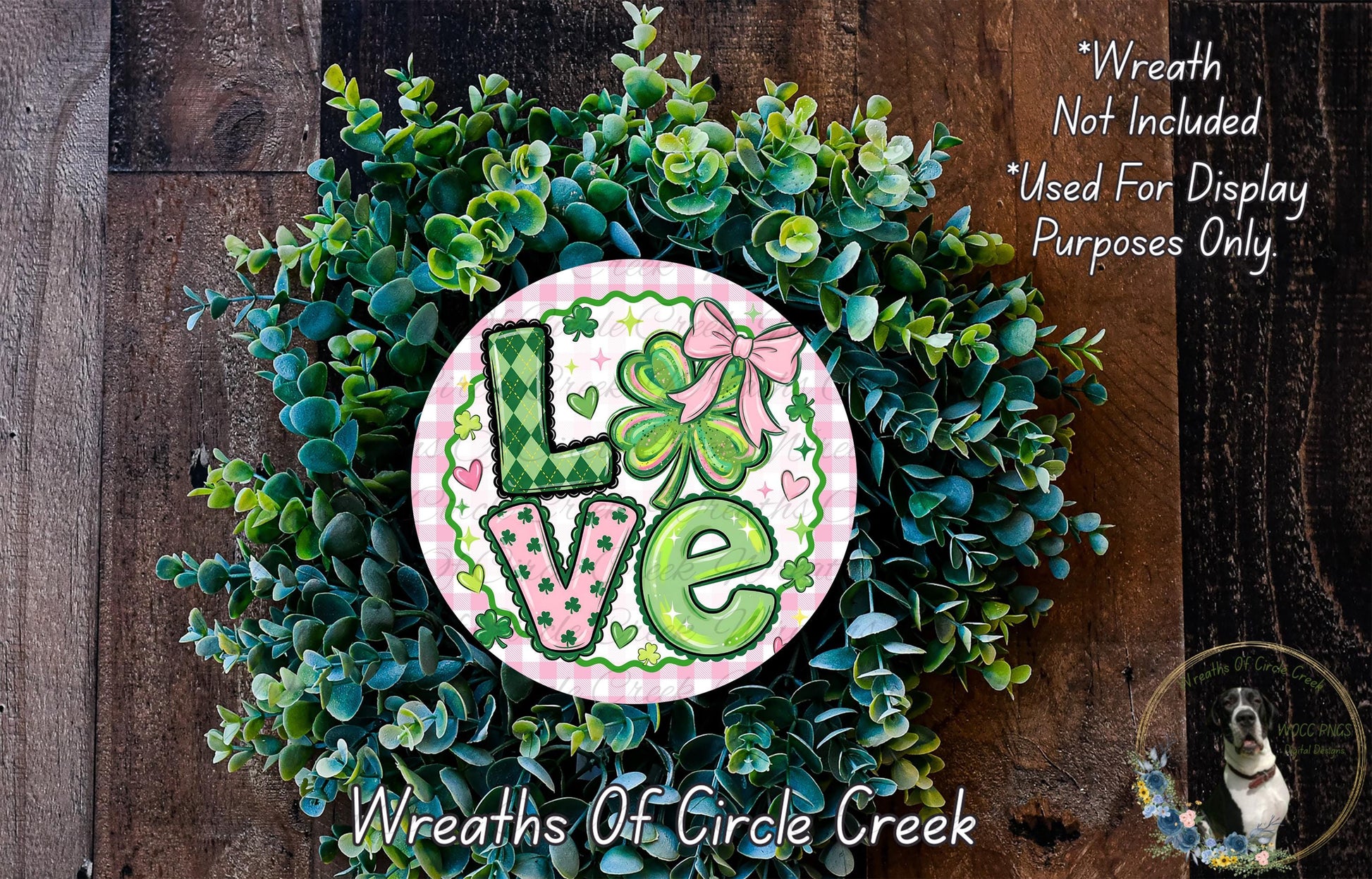 A wreath made of green leaves and flowers, with the word "Love" written on it in a decorative font.