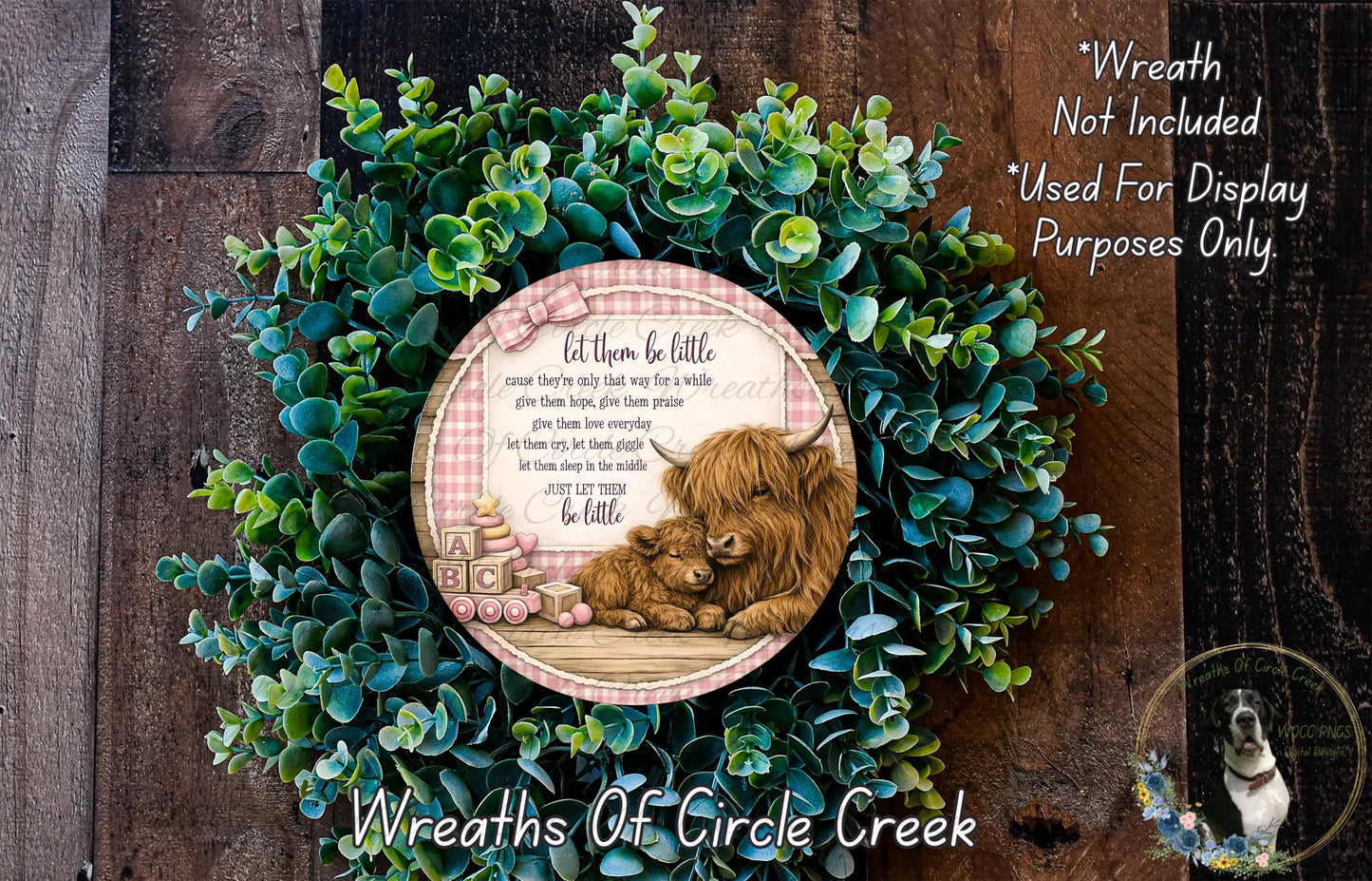 A wreath made of green leaves and a decorative plate featuring a brown cow and a baby cow, with a text overlay that reads "Let them be little, because they're only way to a holy cow. Give them hope, give them praise, let them dream. Let them be happy, let them be proud. Let them be little, let them be proud."