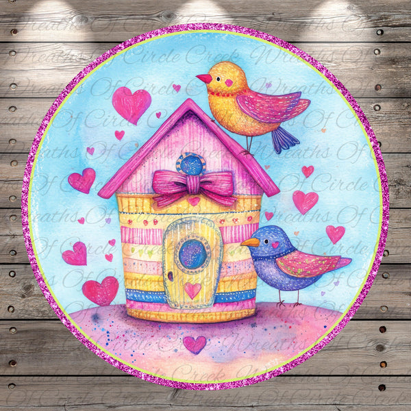 A colorful illustration of a birdhouse with two birds perched on it, surrounded by hearts and a pink border.