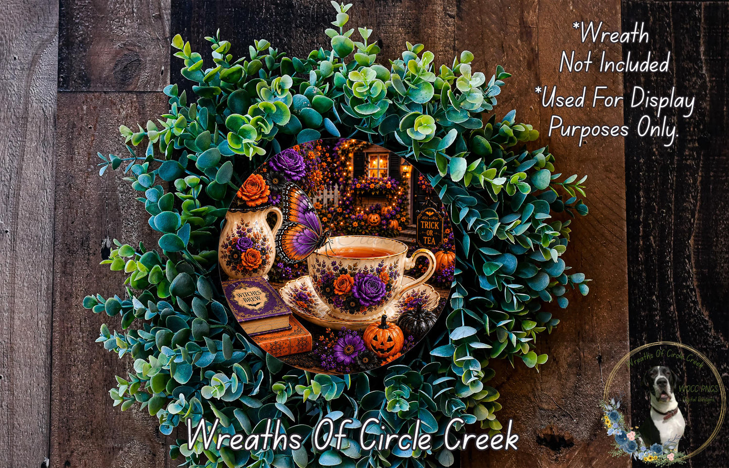 A wreath made of various colorful flowers, leaves, and a teacup, with a pumpkin and books on the surface.