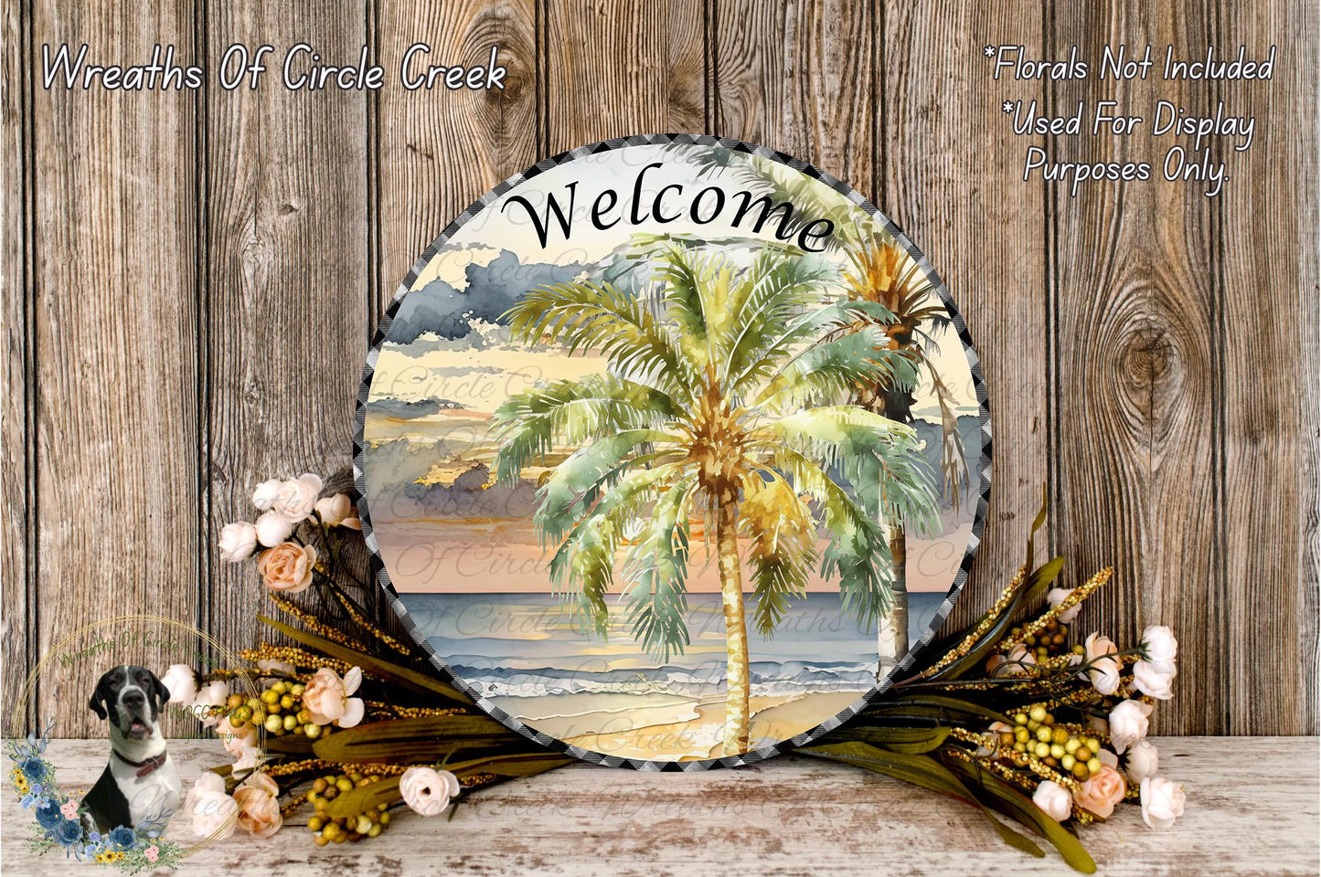 a circular welcome sign with a tropical beach scene, surrounded by a wreath of flowers and a palm tree.